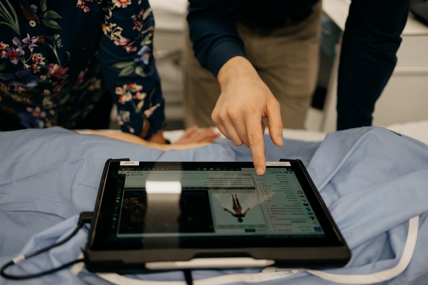 people in a hospital with a tablet computer