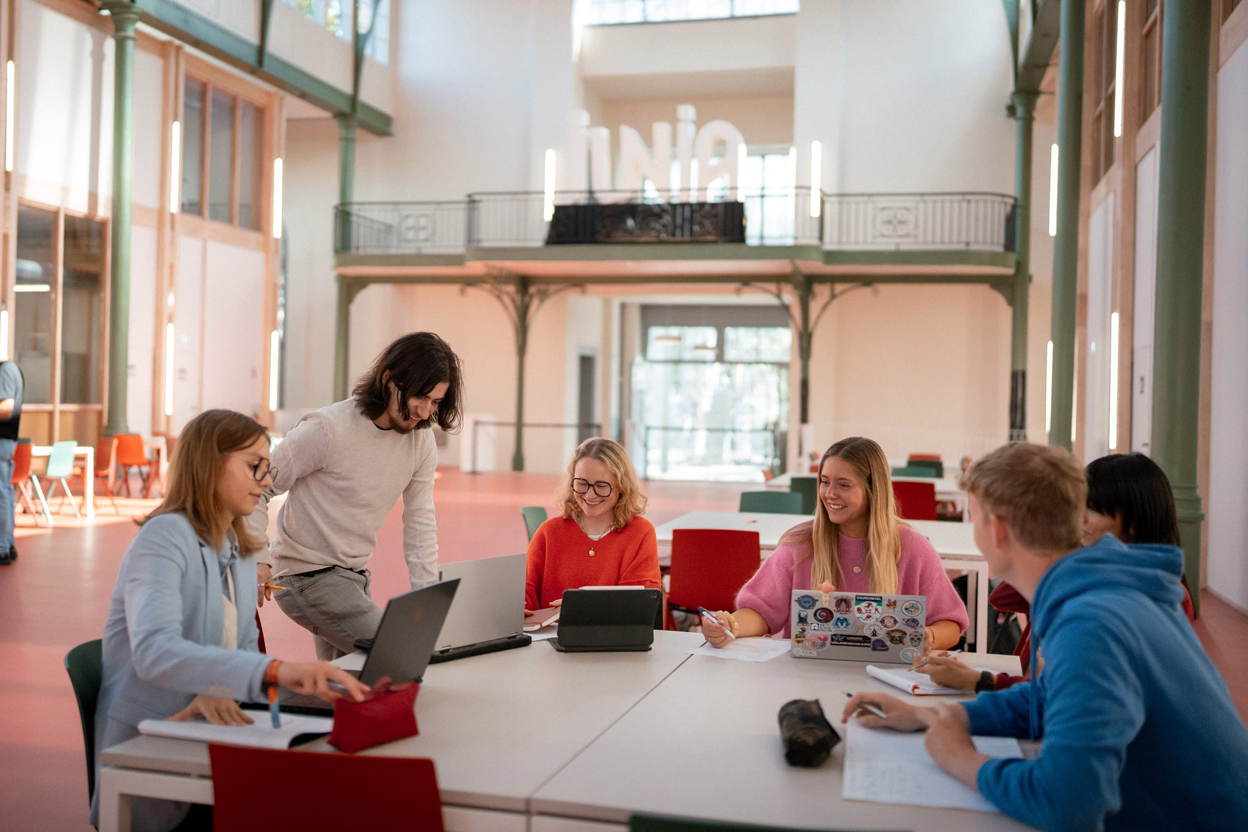 A group of students gathered around a table at the Palais Rameau