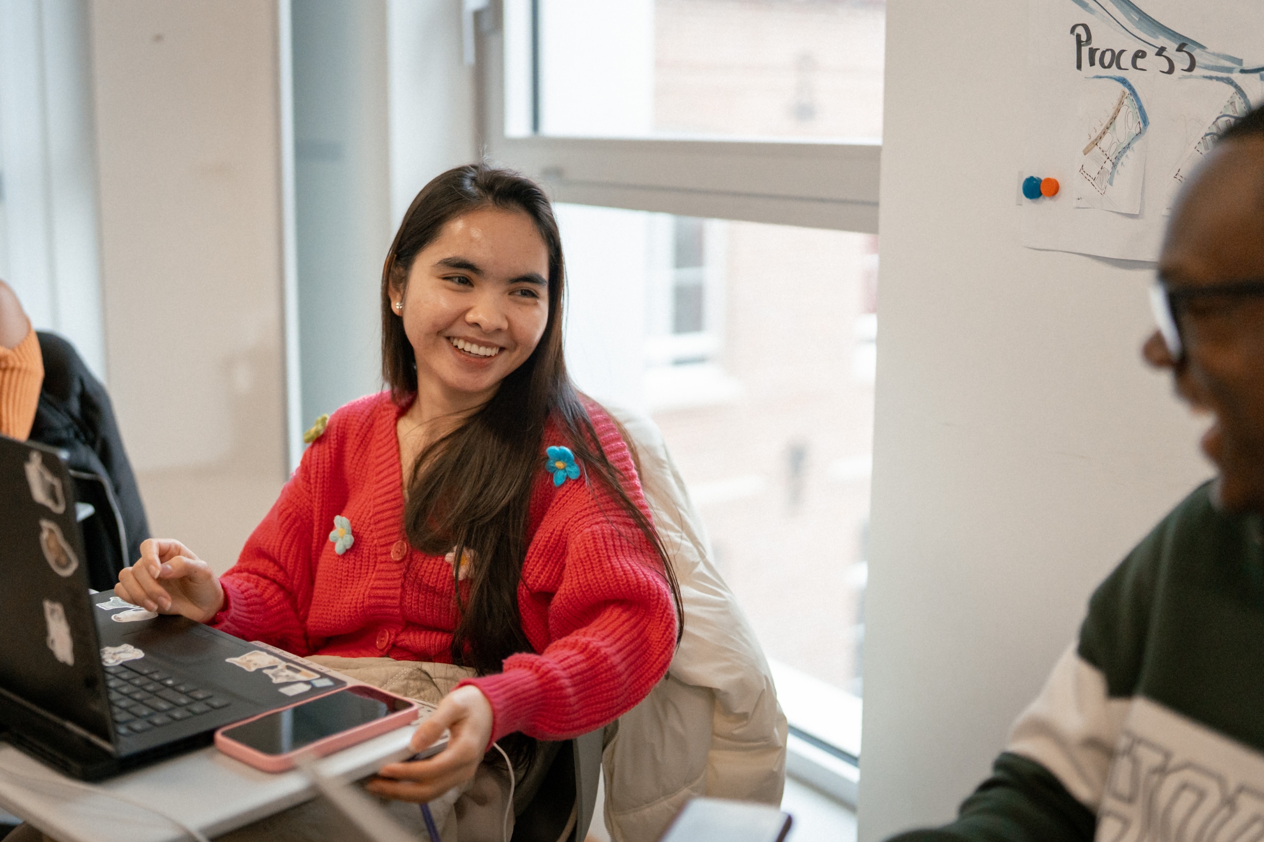 A student wearing a pink sweater