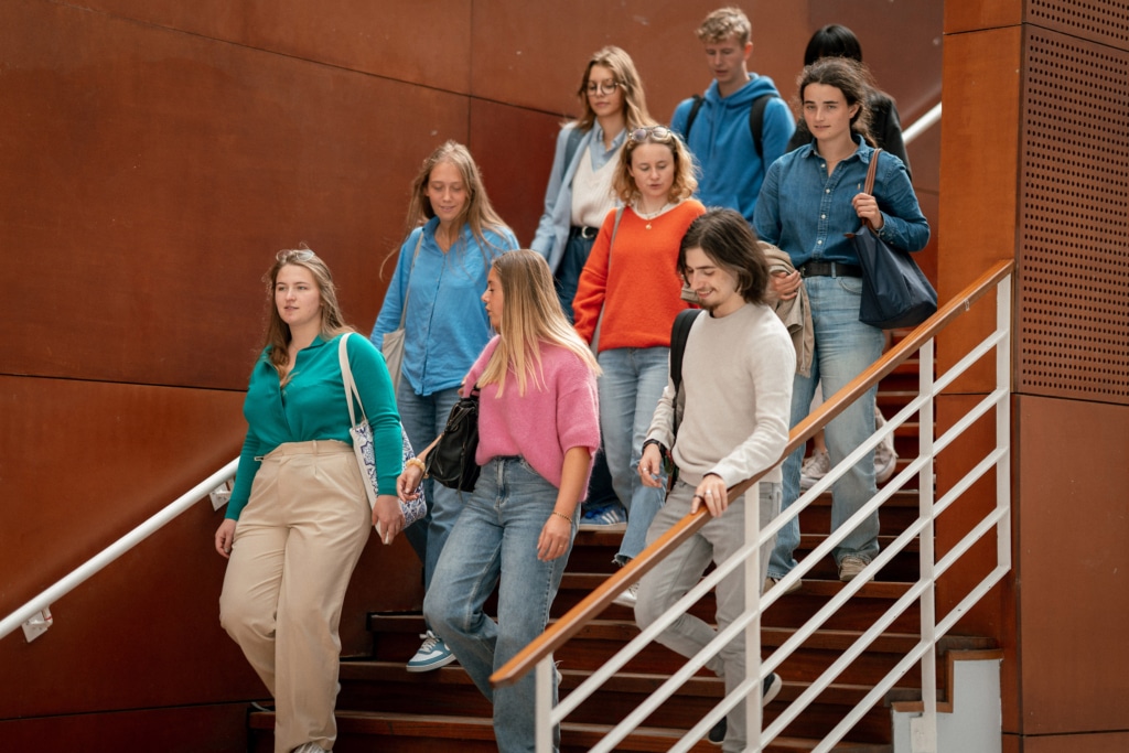 Students walking down the stairs of one of JUNIA's building