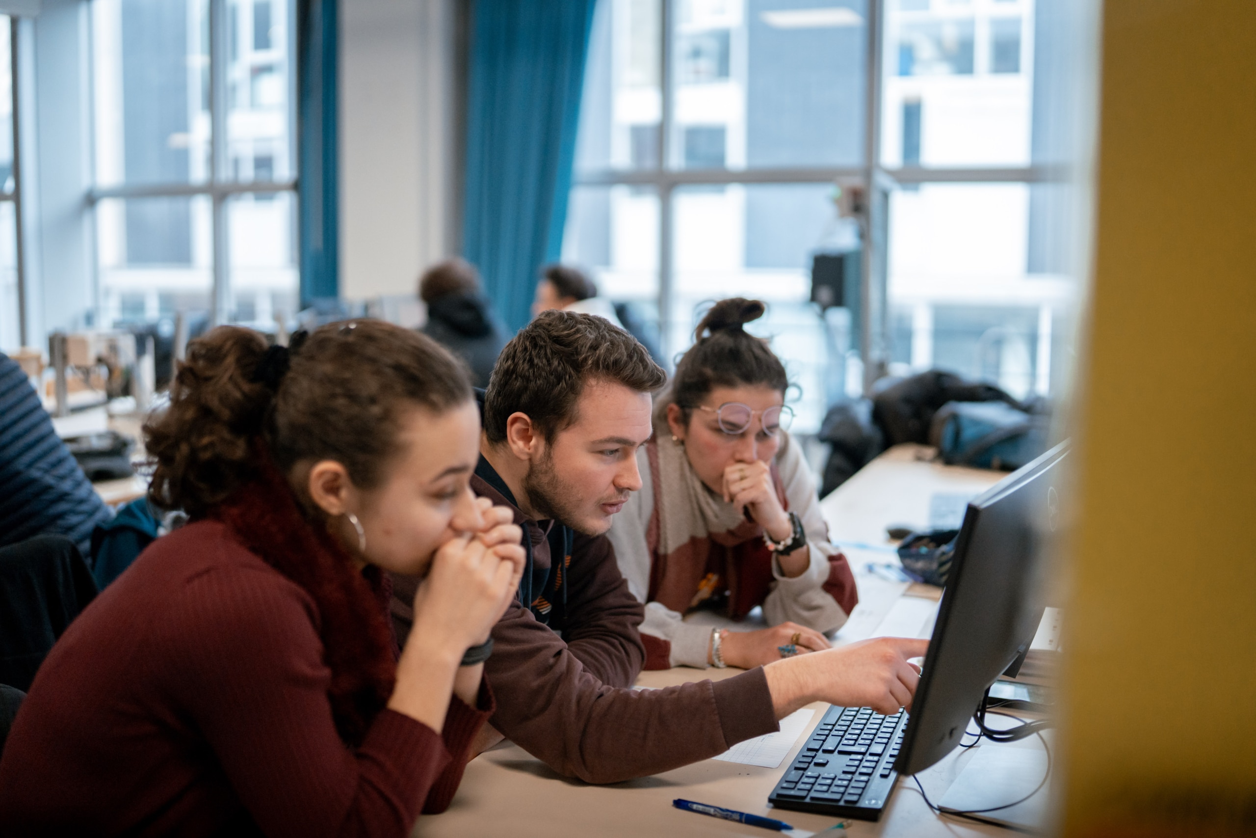 Students working together in front of a computer