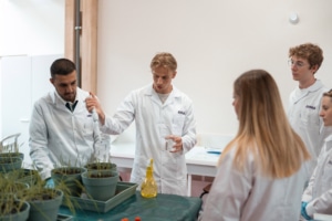 Students making analysis on plants and soil in a lab