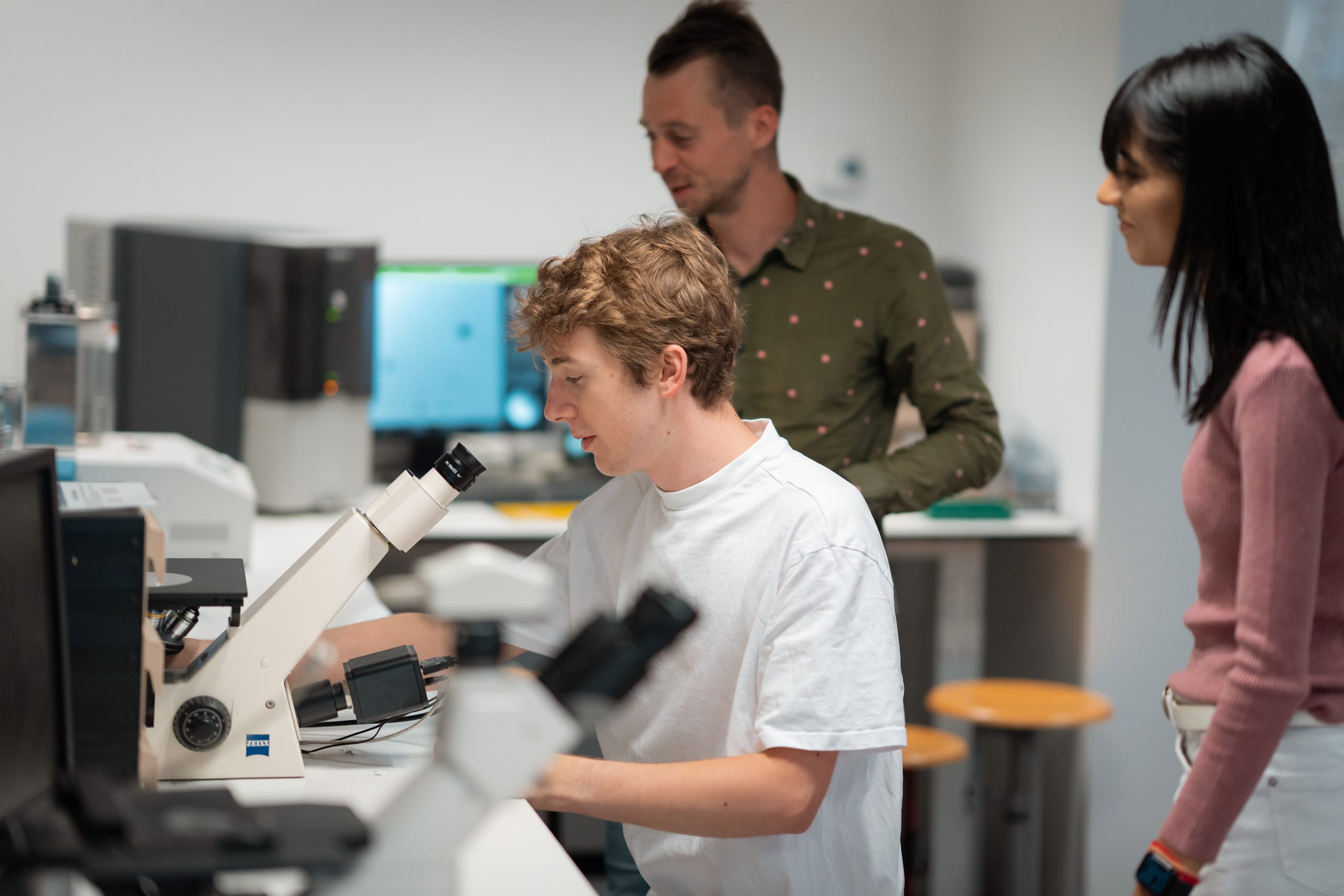 Students in a lab using a microscope