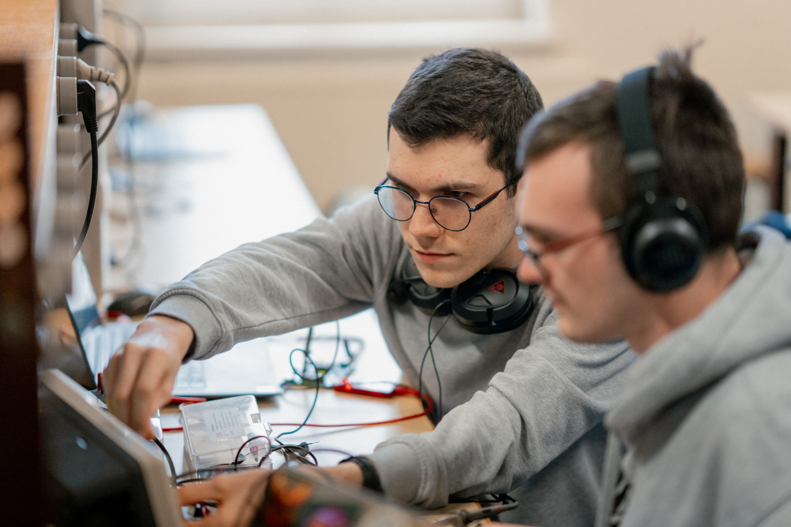 Students working with cables and headphones